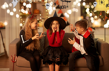 Image showing kids in halloween costumes playing at home