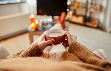 Image showing hands of woman drinking hot chocolate at home