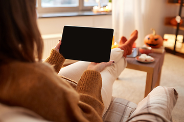 Image showing woman with tablet pc at home on halloween