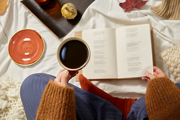 Image showing woman drinking coffee and reading book in autumn