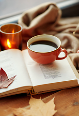 Image showing cup of coffee, book on window sill in autumn