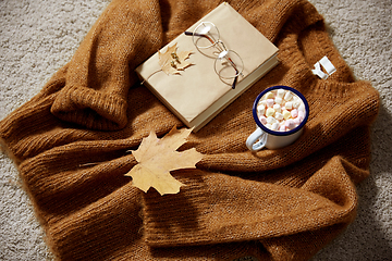 Image showing cup of marshmallow, book and glasses on sweater