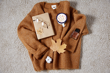 Image showing cup of marshmallow, book and glasses on sweater