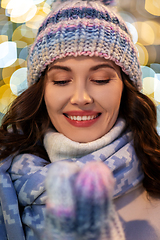 Image showing portrait of happy young woman in christmas lights