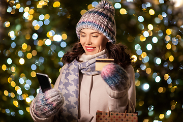 Image showing woman with phone, credit card and christmas gifts