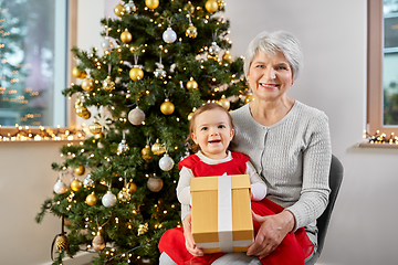 Image showing grandmother and baby girl with christmas gift