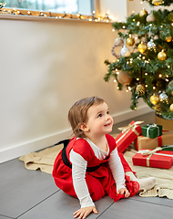 Image showing happy baby girl with christmas gifts at home