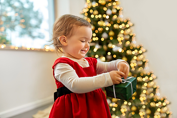 Image showing happy baby girl with christmas gift at home