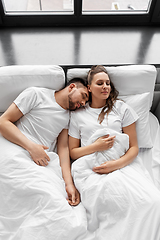 Image showing happy couple sleeping in bed at home