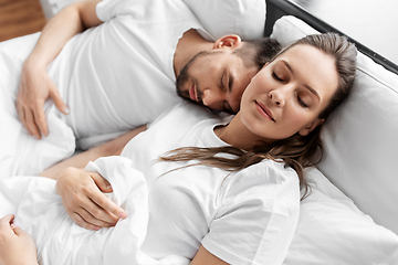 Image showing happy couple sleeping in bed at home