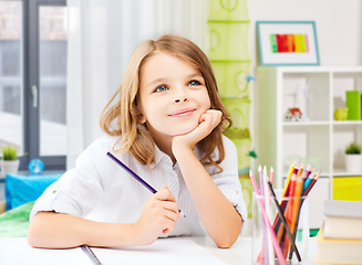 Image showing happy girl drawing with pencils at home