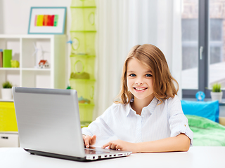 Image showing smiling student girl with laptop computer at home