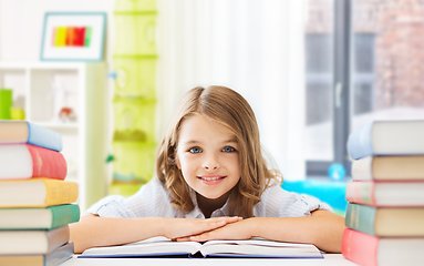 Image showing smiling student girl with books learning at home