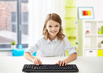 Image showing happy student girl with keyboard at home