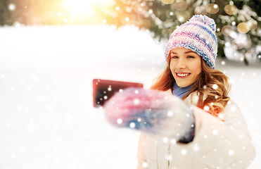 Image showing woman taking selfie by smartphone in winter