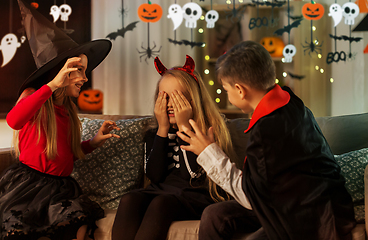 Image showing kids in halloween costumes playing at home