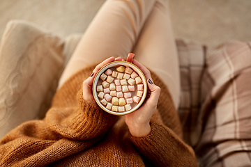 Image showing woman holding mug of hot chocolate and marshmallow