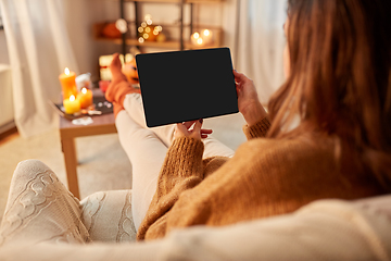 Image showing woman with tablet pc at home on halloween