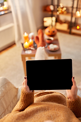 Image showing woman with tablet pc at home on halloween