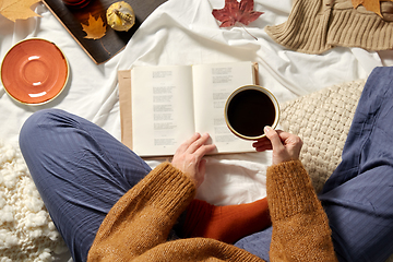 Image showing woman drinking coffee and reading book in autumn