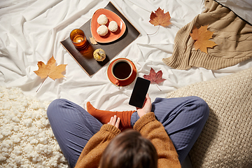 Image showing woman with smartphone at home in autumn