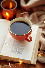 Image showing cup of coffee, book on window sill in autumn