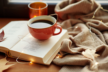 Image showing cup of coffee, book on window sill in autumn