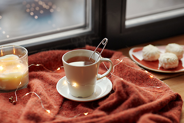 Image showing cup of tea and candle on window sill