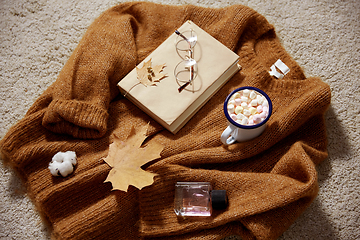 Image showing cup of marshmallow, book and glasses on sweater