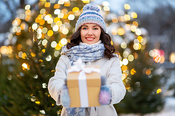 Image showing happy woman with christmas gift over lights