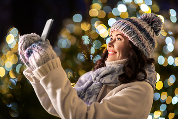 Image showing happy woman taking christmas selfie on smartphone