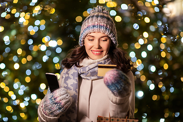 Image showing woman with phone, credit card and christmas gifts