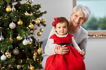 Image showing grandmother and baby girl with at christmas tree