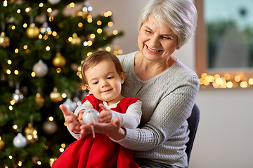 Image showing grandmother and baby girl with at christmas tree