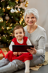 Image showing grandmother and baby girl with christmas gifts