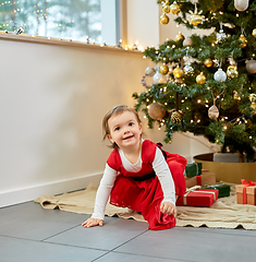 Image showing happy baby girl with christmas gifts at home