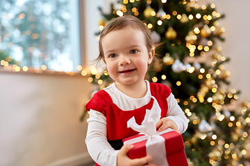 Image showing happy baby girl with christmas gift at home