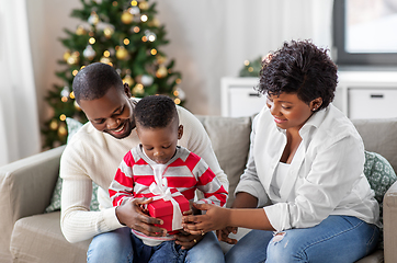 Image showing african family opening christmas gift at home