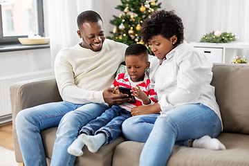 Image showing african family with phone on christmas at home