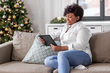 Image showing african woman with tablet pc at home on christmas