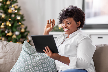 Image showing african woman with tablet pc at home on christmas