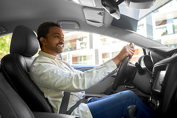 Image showing smiling indian man or driver driving car