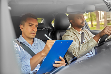 Image showing car driving school instructor and young driver