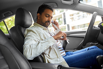 Image showing indian man or driver fastening seat belt in car