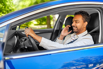 Image showing indian man driving car and calling on smartphone