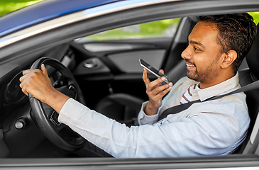 Image showing man driving car and recording voice by smartphone