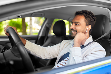 Image showing man or driver with wireless earphones driving car