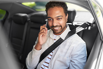 Image showing male passenger calling on smartphone in taxi car