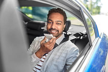 Image showing male passenger calling on smartphone in taxi car