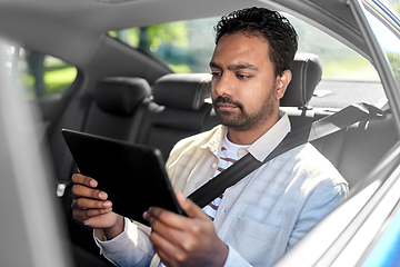 Image showing indian male passenger with tablet pc in taxi car